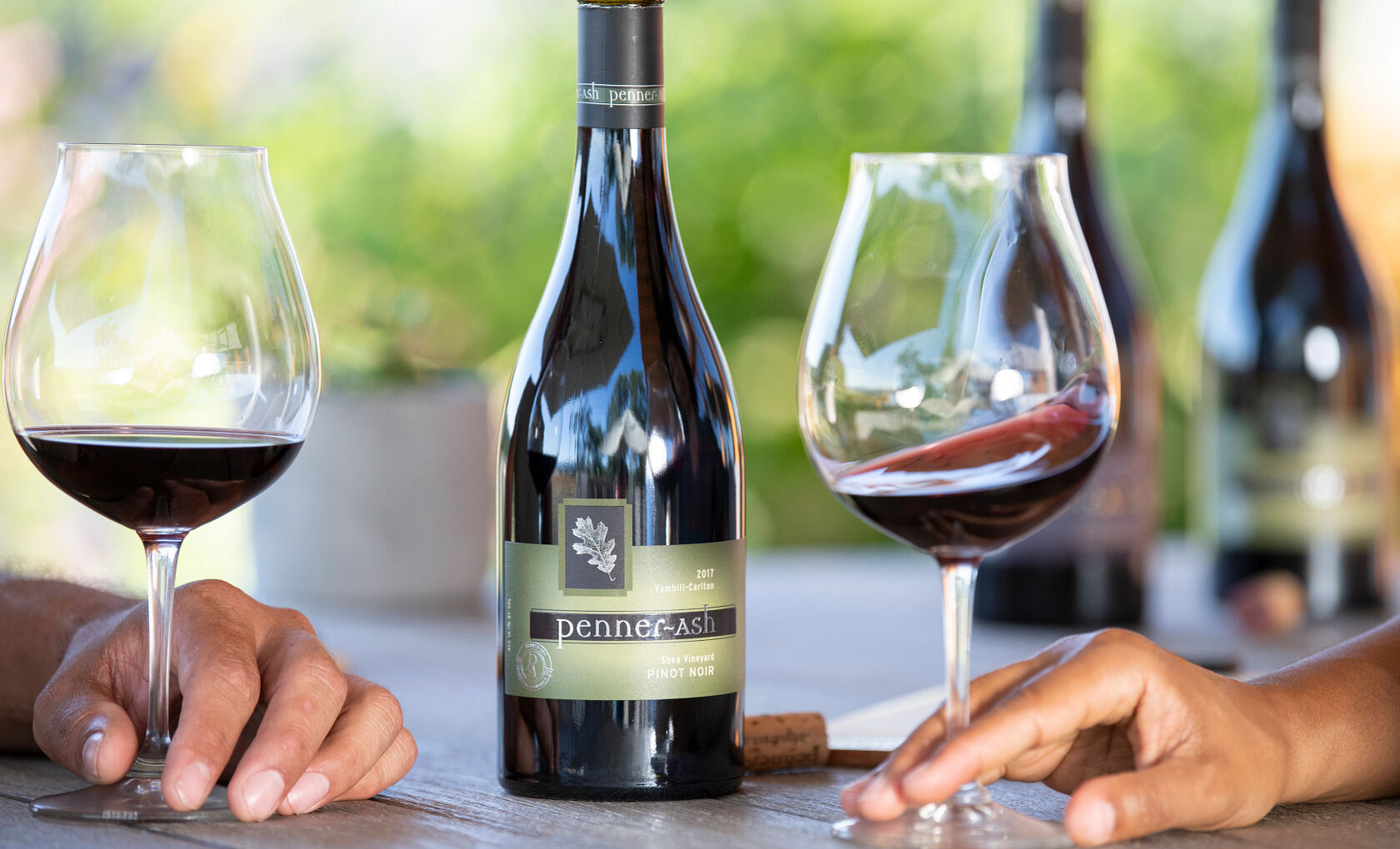 Guests at Penner-Ash Cheersing with wine glasses.